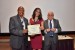 Dr. Tilia Stingl De Vasconcelos receiving the certificate and the medal of her designation as "Inter-Disciplinary Communication" Fellow of the IIIS.